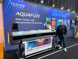 Carl Criscione standing with the Fujifilm Acuity Triton at FESPA